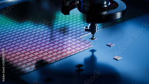 Close-up of Semiconductor Packaging Process. Computer Chips are being Extracted by a Pick and Place Machine from a Wafer and Attached to a Substrate. Microchip Manufacturing at a Factory.