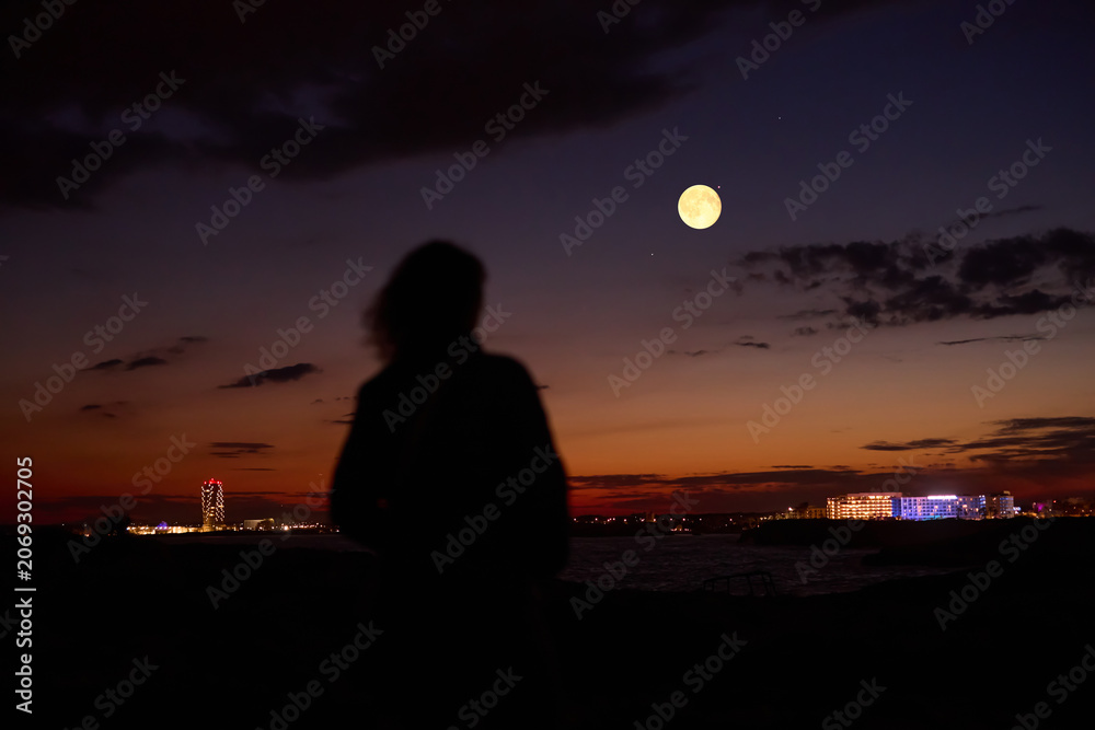 Fototapeta premium Woman observing stars, planets, Moon and other celestial objects.