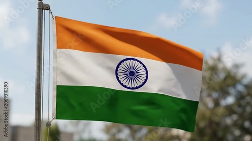 Indian flag waving on a flagpole under blue sky outdoors