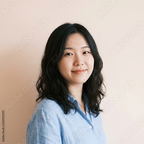 A Young East Asian Woman Wearing A Light Blue Linen Casual Shirt