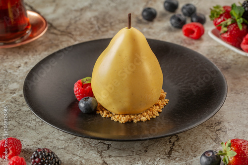 Photos Sophisticated Pear-Shaped Glazed Dessert with a Crumble Base and Fresh Berries o