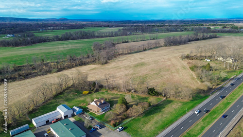Rural landscape corridor transition showcases expansive agricultural plots alongside US 202. Wide angle perspectives define geographic scope, land use patterns surrounding commercial hub, NJ