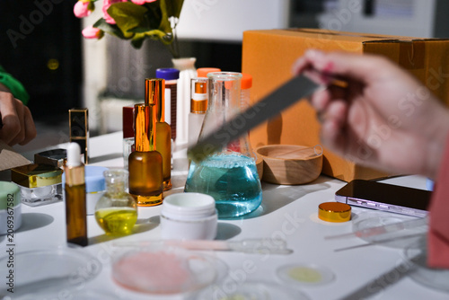 Canvas Print Woman making organic cosmetics with aloe in laboratory
