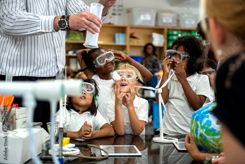 Photos Children engaged in science experiment.