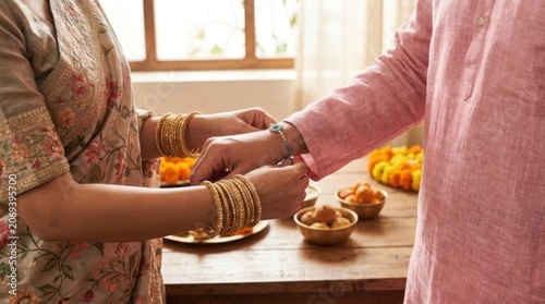 Woman Tying Rakhi Bracelet