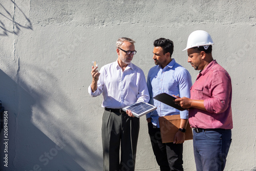 Photos Professionals discussing solar technology photo