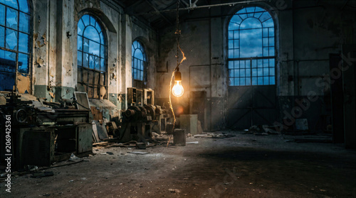 Single Hanging Light Bulb in an Abandoned Industrial Warehouse