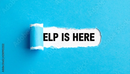Torn Blue Paper Revealing Bold Black Text Help Is Here Representing Support, Assistance, Guidance, and Motivational Encouragement