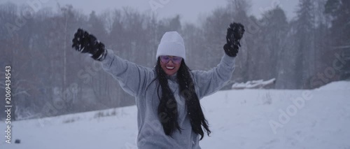 Happy Latina Woman from Colombia Enjoying Snow in Germany During Winter