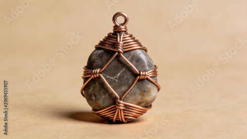 Copper-wrapped stone pendant on neutral background