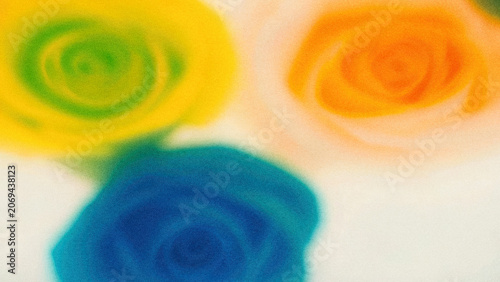 Brightly colored roses in green, yellow, and orange on a light surface showing a vibrant floral arrangement