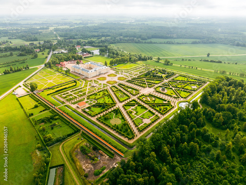 Aerial view of Rundale Palace Museum with its elaborate baroque formal gardens, geometric hedges, and surrounding green fields in Pilsrundale, Bauska Municipality, Latvia.