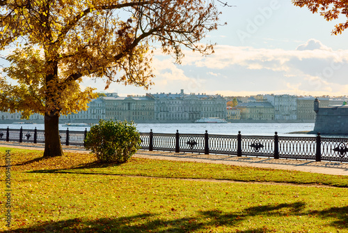 Isaac cathedral, Winter Palace, picturesque metal railings with a double-headed eagle and the crown of the Russian Empire on embankment in St. Petersburg, autumn sunset, incredible sun glare, Russia