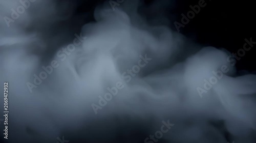 Thick white smoke or cloud swirling and filling a dark empty space with soft organic movement. Concept of abstract mystery and atmospheric backdrop