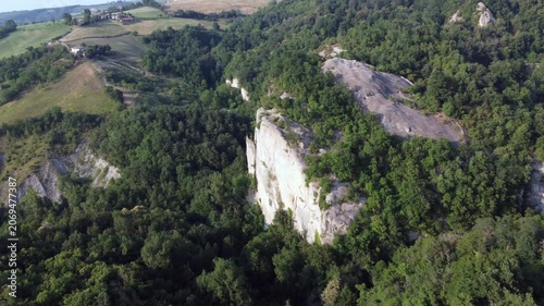 Aerial view of Sasso di Sant Andrea, a prominent sandstone geological feature surrounded by dense forest. Zocca, Modena, Emilia-Romagna, Italy