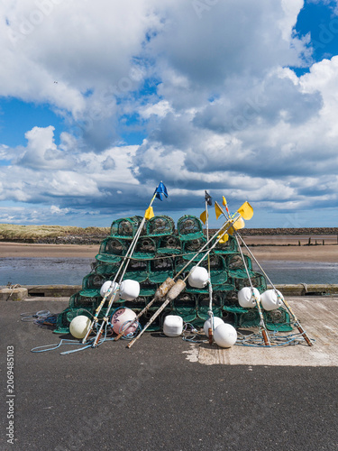 Lobsterpots and marker flags at Amble, Northumberland, UK