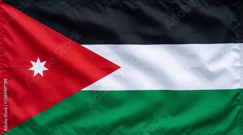 Jordanian flag waving proudly, symbolizing unity, faith, and heritage through colors, triangle, and star…