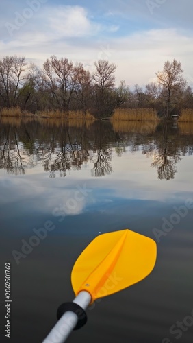 Kayak Paddle on Tranquil Lake with Tree Reflections