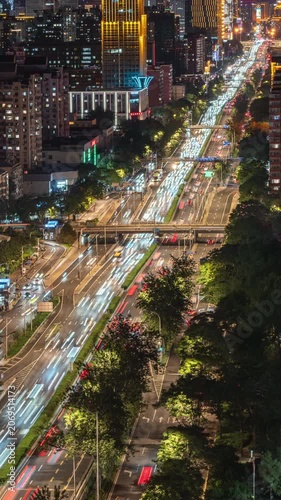 Time-lapse footage of traffic light trails and residential areas in Beijing's East Third Ring Road, showcasing urban development.