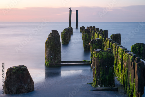 Long exposure photograph of the waterfront at Buckroe Beach in Hampton Virginia on a peaceful morning around sunrise