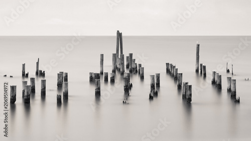 Obraz na plátně Long exposure image of pylons at the oceanfront with smooth calm and peaceful lo