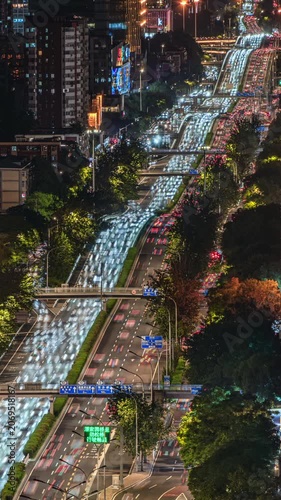 Traffic flow patterns at the East Third Ring Road overpass in Beijing, urban night view, and urban development.