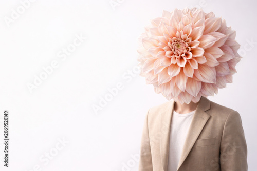 Person in beige blazer with a pink flower instead of a head. Space for text.