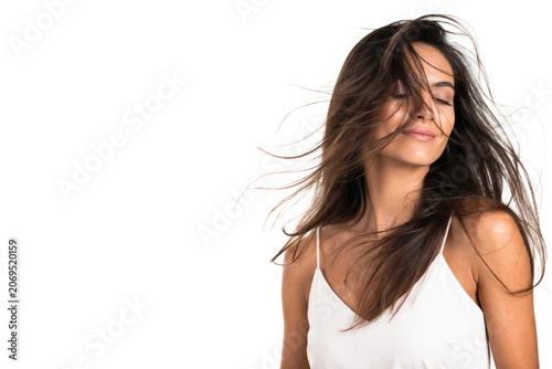 Woman portrait with windblown hair on a white background. Space for text.