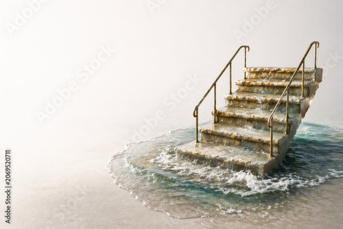 Stone staircase with metal railings standing in shallow water. Space for text.