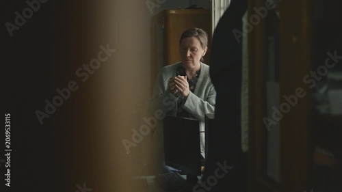 Woman enjoying coffee in vintage library workspace, soft daylight through the window, she is being watched behind the library shelves, 4K
