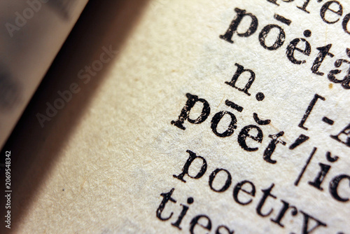 Photos Word poetic on dictionary page, macro close up