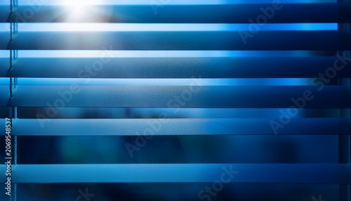 Abstract Blurred Light Through Window Blinds With Dark Blue Gradient Background