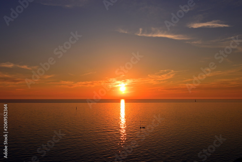 Quadro su tela A magnificent and very bright sunset over the southern sea.