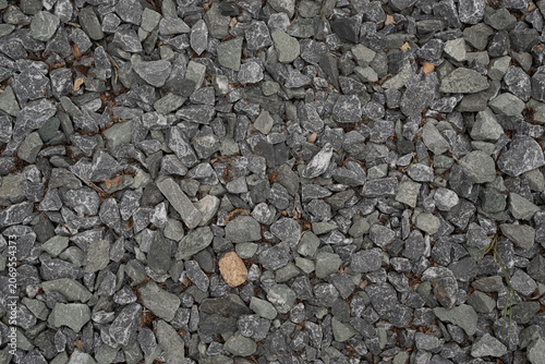 Принти на полотні Dark crushed stone background with natural rock texture details fills the frame