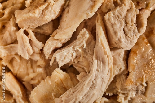A bowl of cooked chicken pieces.