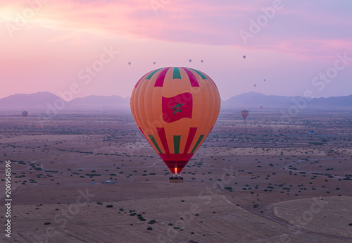 Billede på lærred Une montgolfière avec une flamme, dans le ciel du Maroc, au lever du soleil
