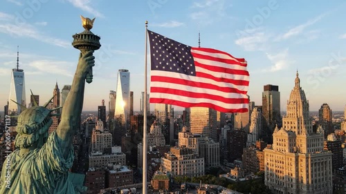 Statue of liberty torch and waving american flag with new york city skyline at sunset, iconic usa patriotism and travel landmark