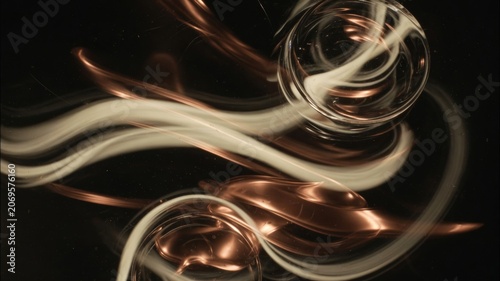 Abstract flowing copper and light trails creating dynamic shapes and energetic movement on a dark background