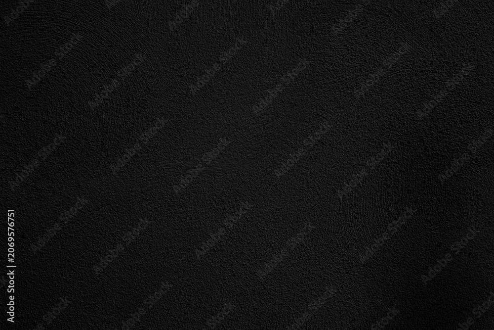 Fototapeta premium Textura de pared grunge negra, fondo superficial oscuro y rugoso. Superficie de pared oscura, rugosa y granulada con textura de ruido sutil. Fondo versátil para diseño editorial y de carteles.