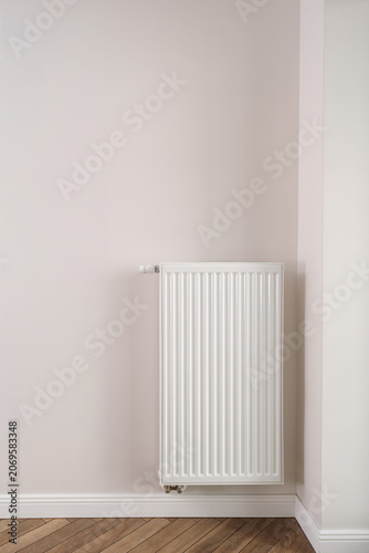 Tableau sur toile Home heating radiator mounted on wall in modern apartment room