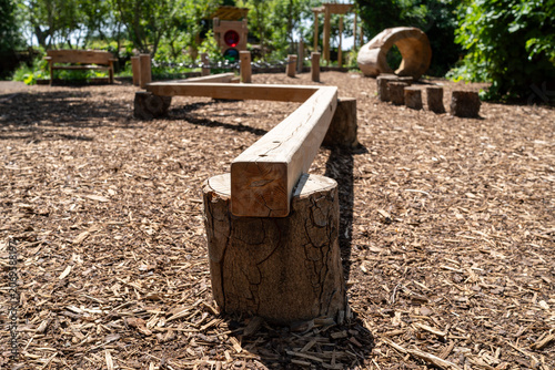 Konstfotografi Close-up of Wooden Balance Beam on Mulch Ground in Outdoor Children's Playground