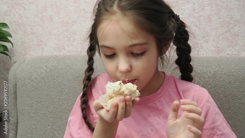 Eating, cupcake and portrait of child for dessert, sweet treat or sugar snack . Bite, tasting and girl with vanilla cake for confection, hungry and enjoy delicious food. Happy childhood: a child enjoy