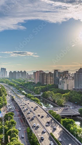 Time-lapse photography of Beijing, China: Modern urban elevated highways, traffic flow, and building complexes.