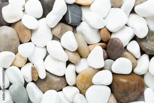White pebble stones as background, top view