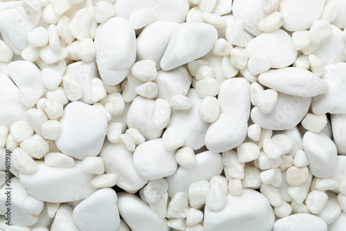 White pebble stones as background, top view