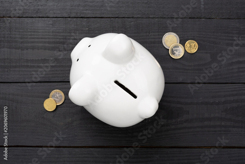 Piggy bank on wooden background, top view