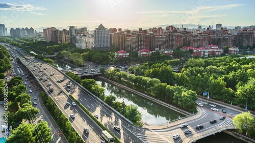 Traffic congestion delayed at overpass along Beijing's moat in the afternoon sun.