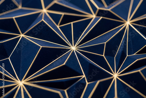 Abstract dark blue geometric pattern with vibrant gold lines background
