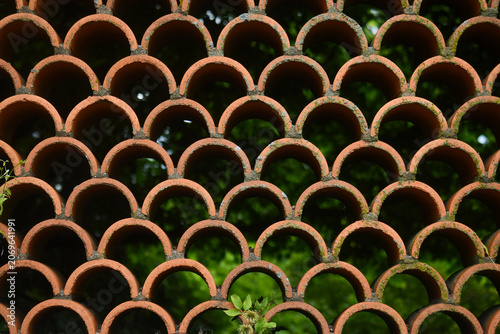 Terracotta semicircles arranged in a scalloped pattern