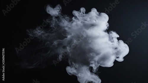 A thick puff of white smoke rises against a solid black background